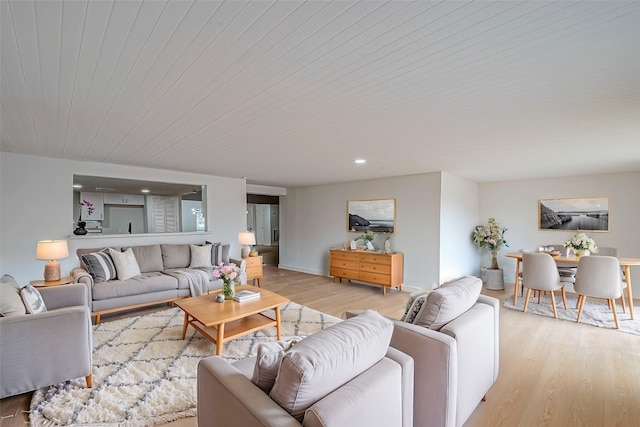 living room featuring wood ceiling and light hardwood / wood-style flooring