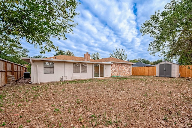 rear view of house featuring a shed and cooling unit