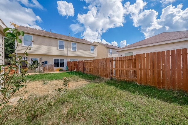 back of house with a yard