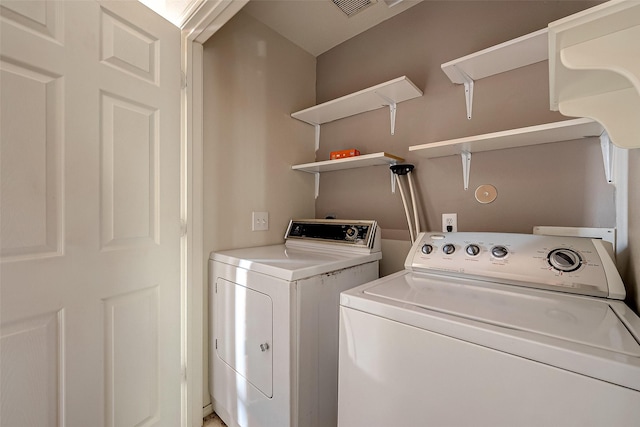 laundry room featuring separate washer and dryer