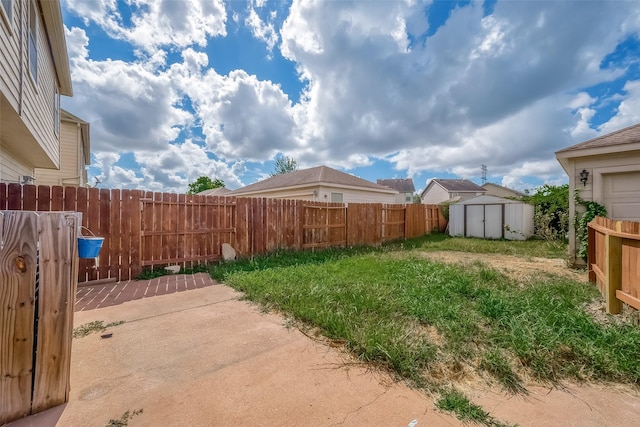 view of yard featuring a patio and a shed