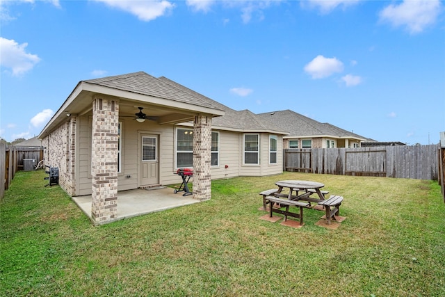 back of property with central AC, ceiling fan, a patio, and a lawn