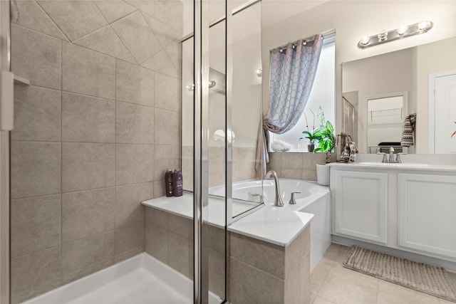 bathroom with tile patterned floors, separate shower and tub, and vanity