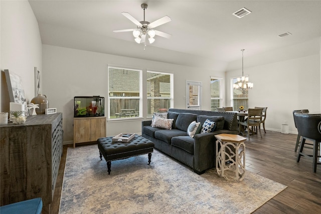 living room featuring dark hardwood / wood-style floors and ceiling fan with notable chandelier