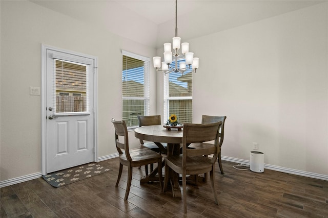 dining area featuring dark hardwood / wood-style flooring and an inviting chandelier