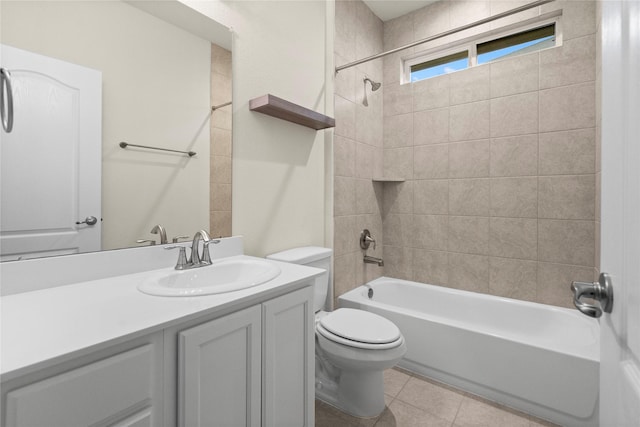 full bathroom with tiled shower / bath combo, vanity, tile patterned floors, and toilet