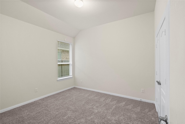 unfurnished room with carpet and lofted ceiling