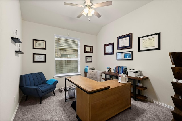 office space with vaulted ceiling, ceiling fan, and dark carpet