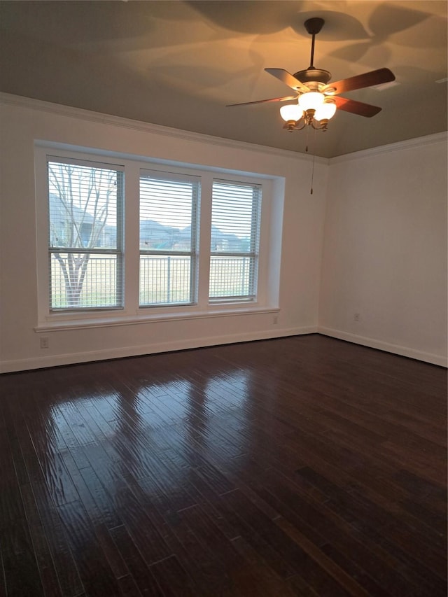 unfurnished room featuring crown molding, dark wood-type flooring, and ceiling fan