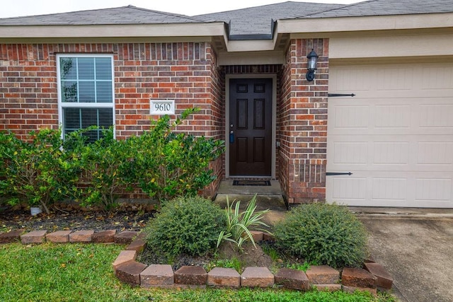 view of exterior entry featuring a garage