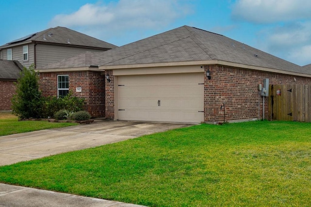 view of side of property featuring a garage and a lawn