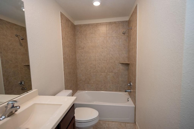 full bathroom with vanity, tile patterned flooring, tiled shower / bath combo, and toilet