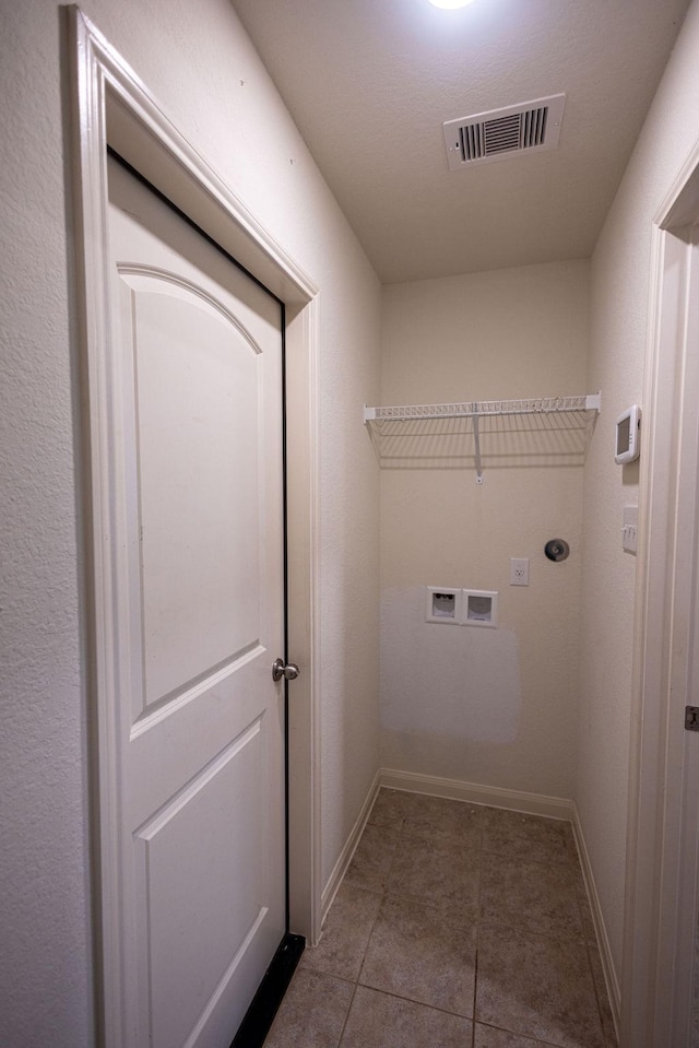 laundry room with tile patterned flooring, hookup for a washing machine, and electric dryer hookup