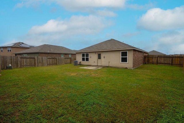 back of property with cooling unit, a yard, and a patio