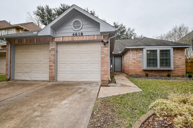 single story home with a garage, concrete driveway, roof with shingles, a front lawn, and brick siding