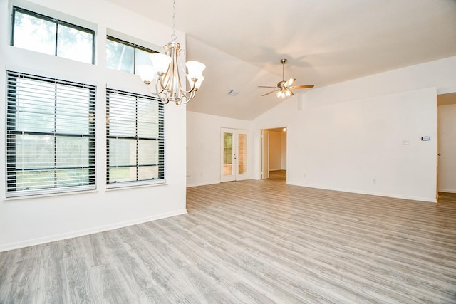 unfurnished living room with lofted ceiling, ceiling fan with notable chandelier, and light hardwood / wood-style floors