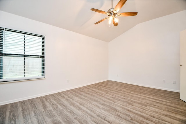 unfurnished room with wood-type flooring, lofted ceiling, and ceiling fan