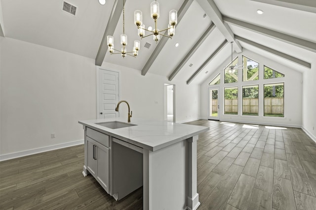 16651 Yaklin Meadow Ct, Humble, TX 77346 - kitchen with a sink, a chandelier, open floor plan, dark wood-type flooring, and baseboards