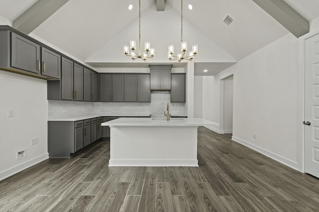 16651 Yaklin Meadow Ct, Humble, TX 77346 - kitchen featuring a chandelier, gray cabinets, dark wood-style flooring, beamed ceiling, and decorative backsplash