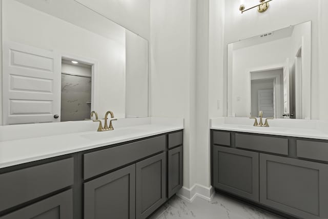 16651 Yaklin Meadow Ct, Humble, TX 77346 - full bath featuring marble look tile flooring, two vanities, and baseboards