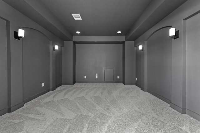 carpeted home theater featuring arched walkways, baseboards, visible vents, and recessed lighting