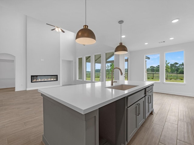 32602 Fly Fish Way, Fulshear, TX 77441 - kitchen with light wood-style flooring, light countertops, open floor plan, pendant lighting, and recessed lighting