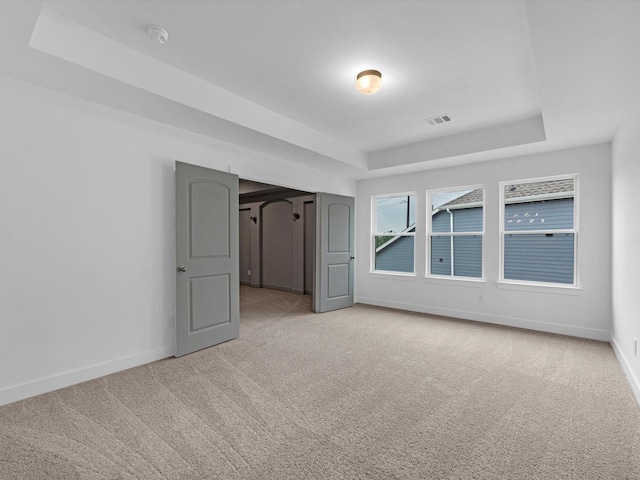 32602 Fly Fish Way, Fulshear, TX 77441 - empty room featuring a raised ceiling, light carpet, and a smoke detector