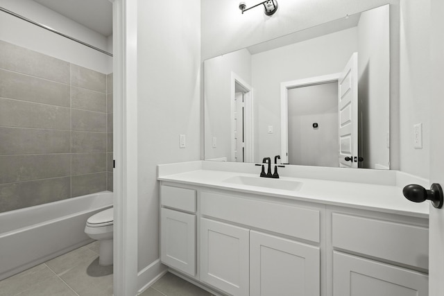 full bathroom featuring tile patterned floors, toilet, tiled shower / bath combo, and vanity