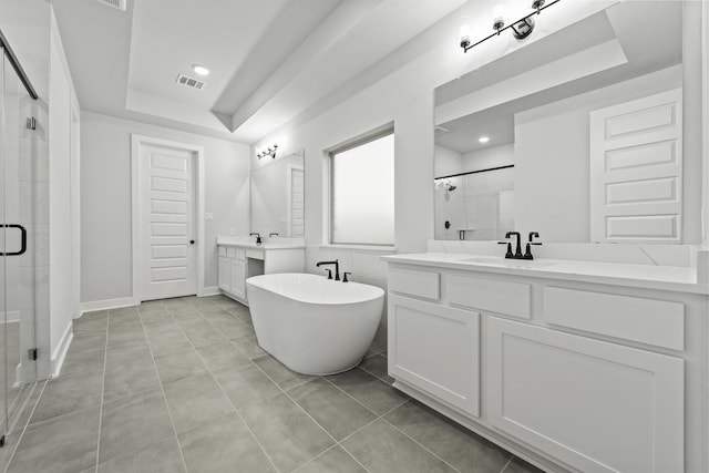 bathroom with tile patterned flooring, shower with separate bathtub, vanity, and a tray ceiling