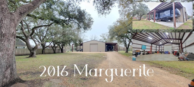 view of yard featuring a carport, a garage, and an outdoor structure