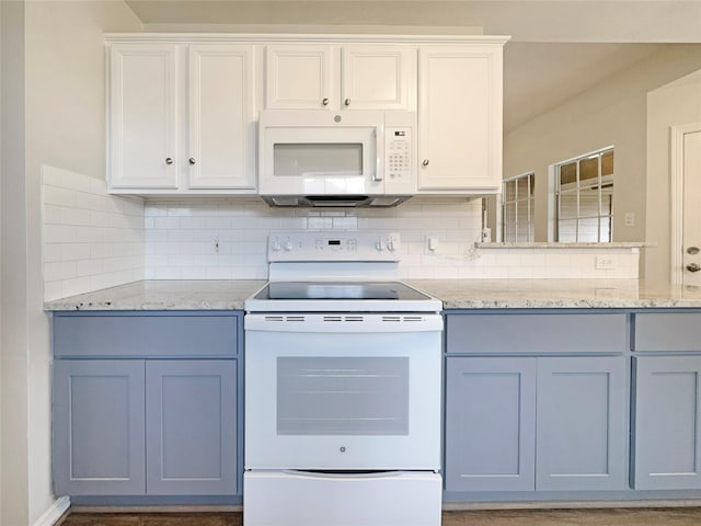 kitchen featuring light stone counters, white cabinets, white appliances, and decorative backsplash