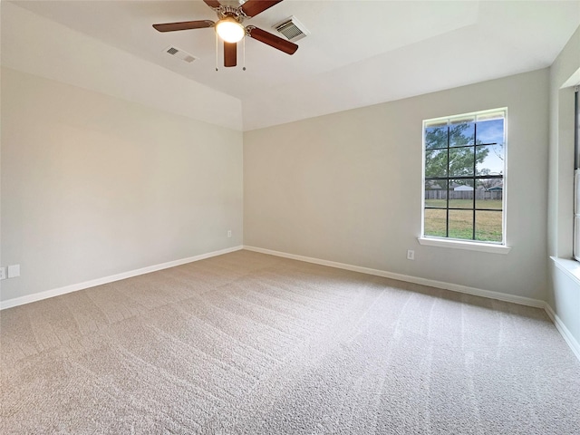 unfurnished room featuring ceiling fan and carpet