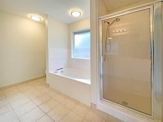 bathroom with independent shower and bath, tile patterned floors, and toilet