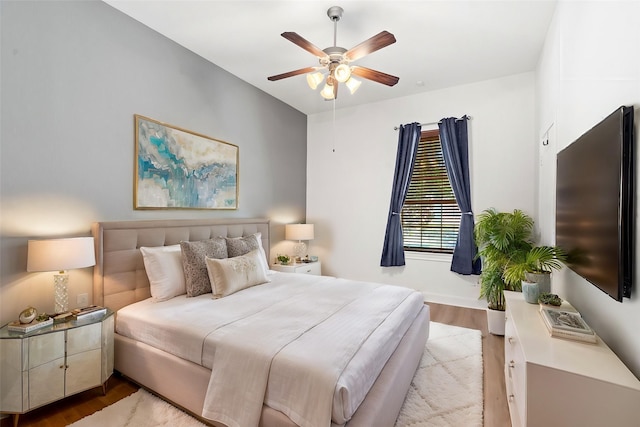 bedroom with ceiling fan and light hardwood / wood-style floors