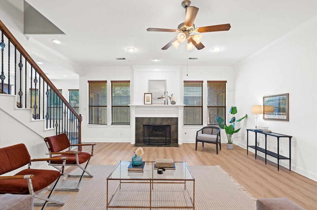 5111 W Jerad Dr, Houston, TX 77018 - living room featuring crown molding, a fireplace, ceiling fan, and light wood-type flooring