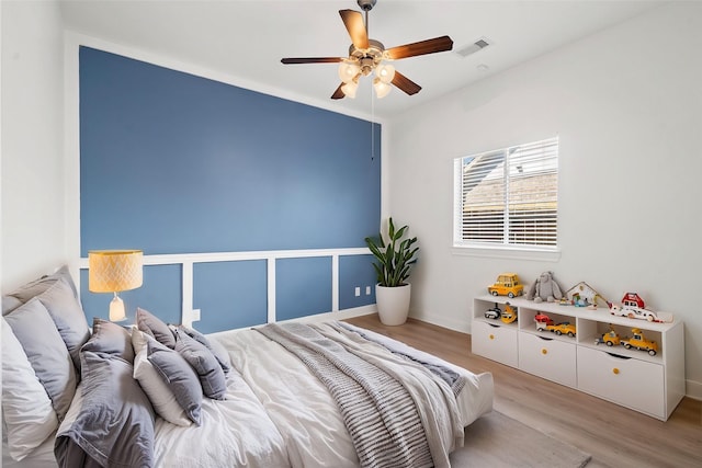 bedroom with ceiling fan and light wood-type flooring