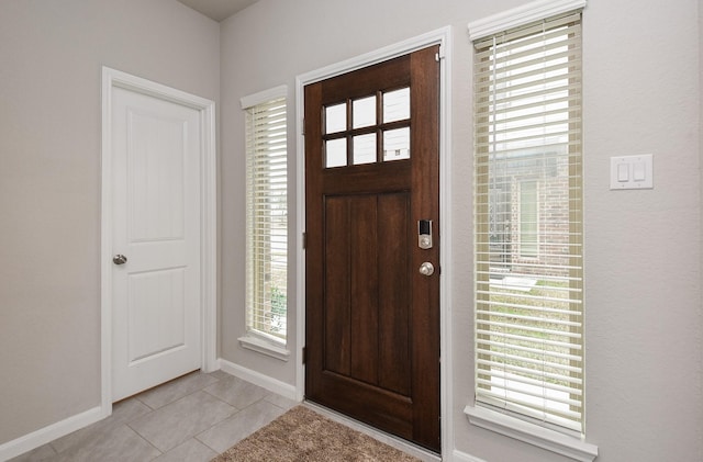 foyer entrance with light tile patterned floors