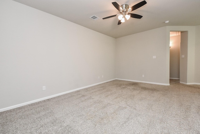 carpeted spare room featuring ceiling fan