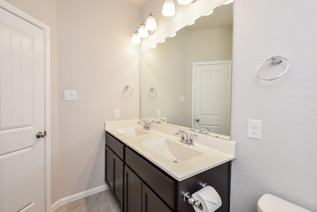 bathroom featuring tile patterned floors, toilet, and vanity