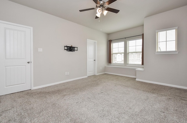 carpeted empty room with ceiling fan