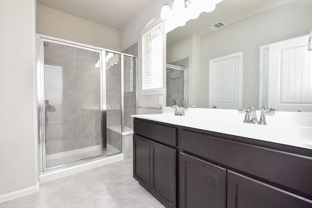 bathroom featuring tile patterned flooring, vanity, and a shower with shower door