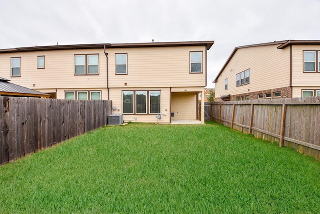 rear view of house with a patio, a yard, and cooling unit