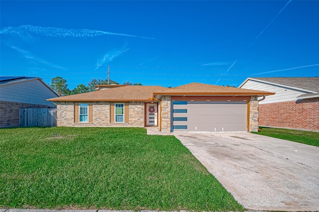 view of front of property with a garage and a front lawn