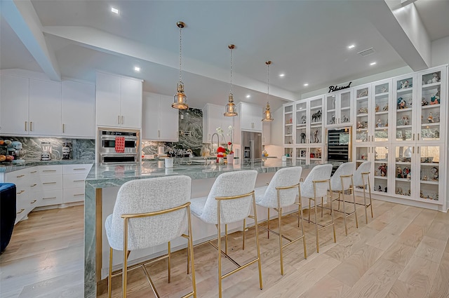 kitchen featuring white cabinets, a breakfast bar, and a spacious island