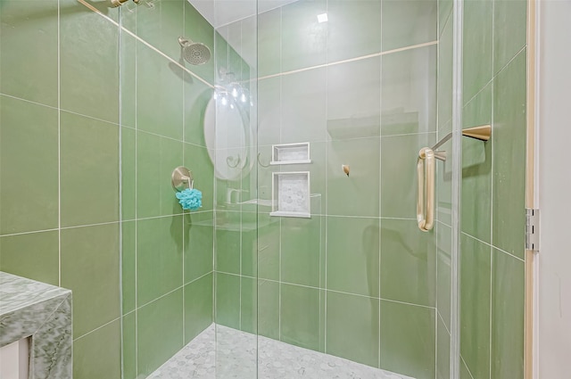 bathroom with a shower with door