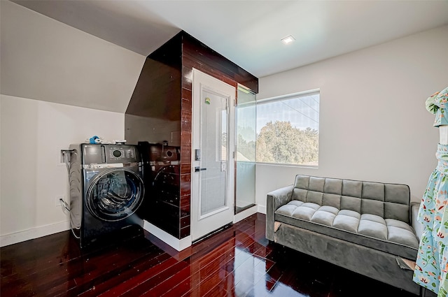 living area featuring vaulted ceiling and dark hardwood / wood-style floors