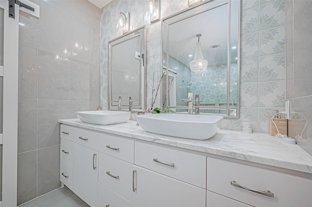 bathroom featuring vanity and tile walls