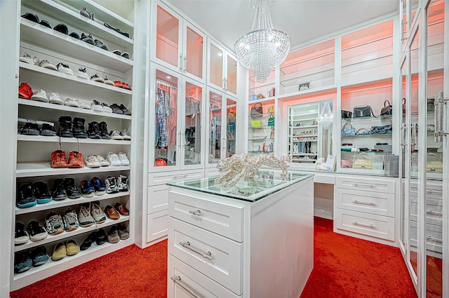 walk in closet with carpet flooring and a notable chandelier