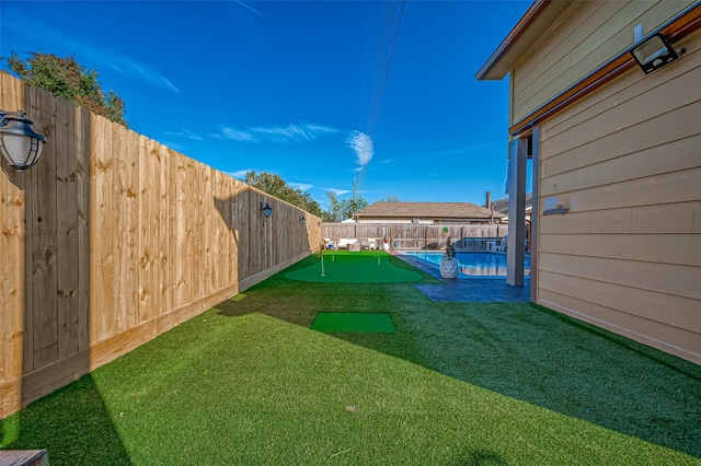 view of yard with a fenced in pool