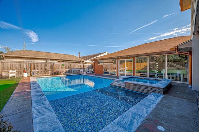 view of swimming pool with a patio and an in ground hot tub